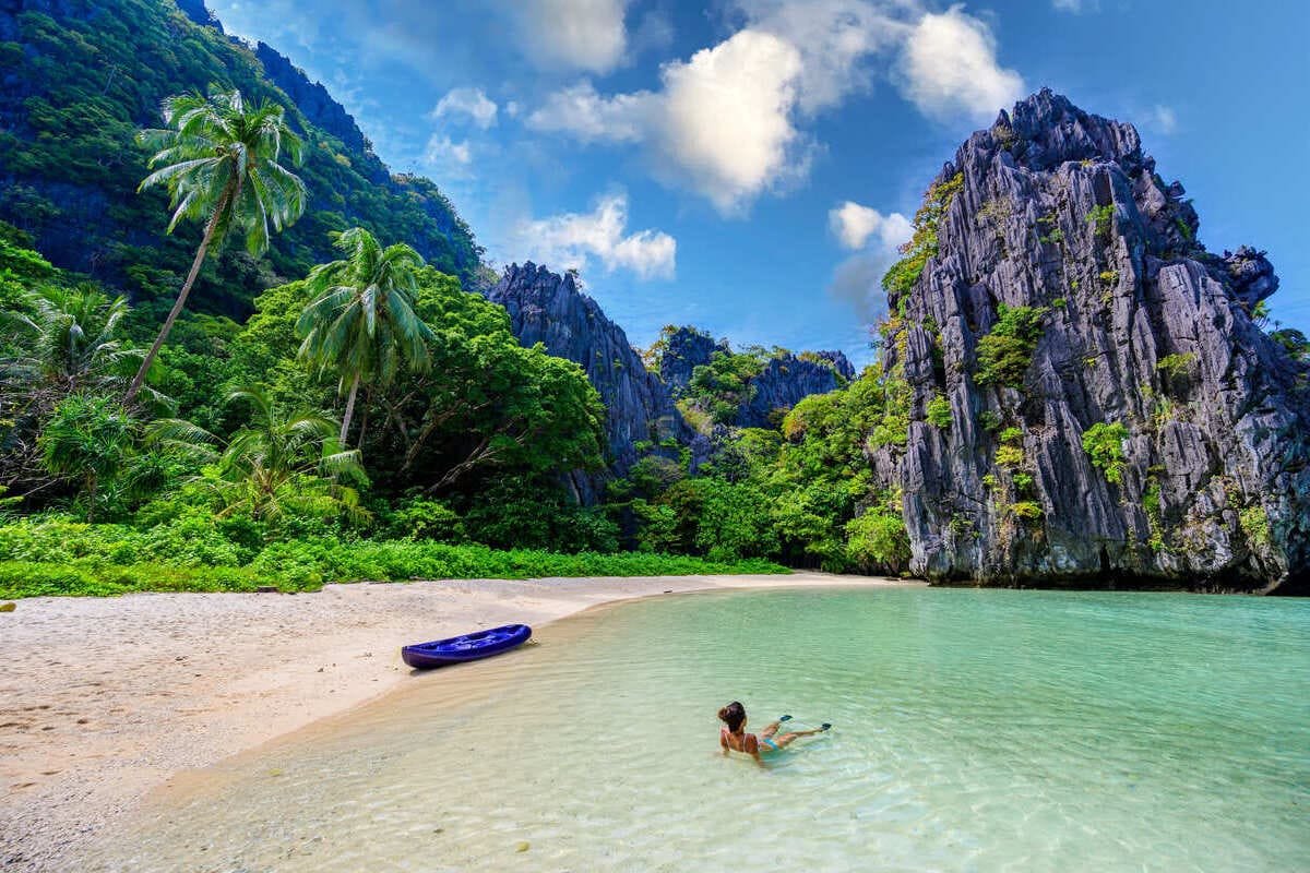 Young Woman Swimming On A Beach In Palawan, Philippines, Southeast Asia